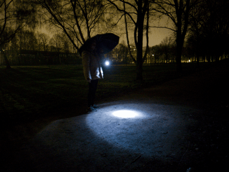 Der BigJoys Regenschirm mit Taschenlampe im dunklen Park